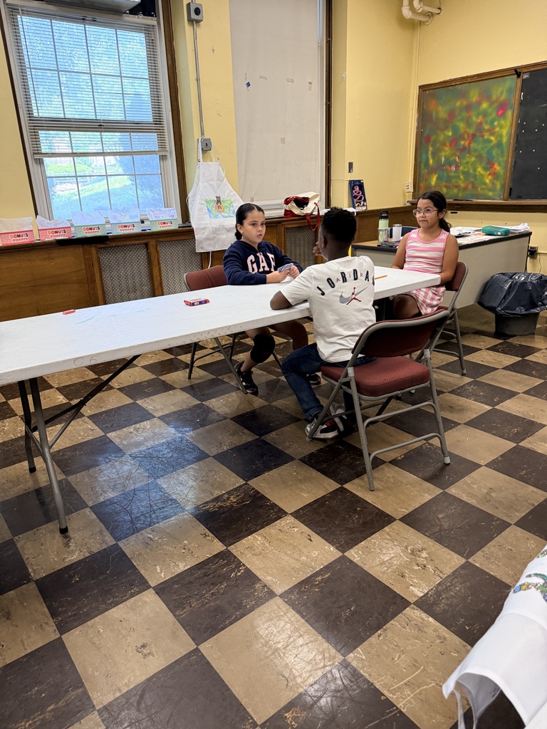 Students working through a camp activity together